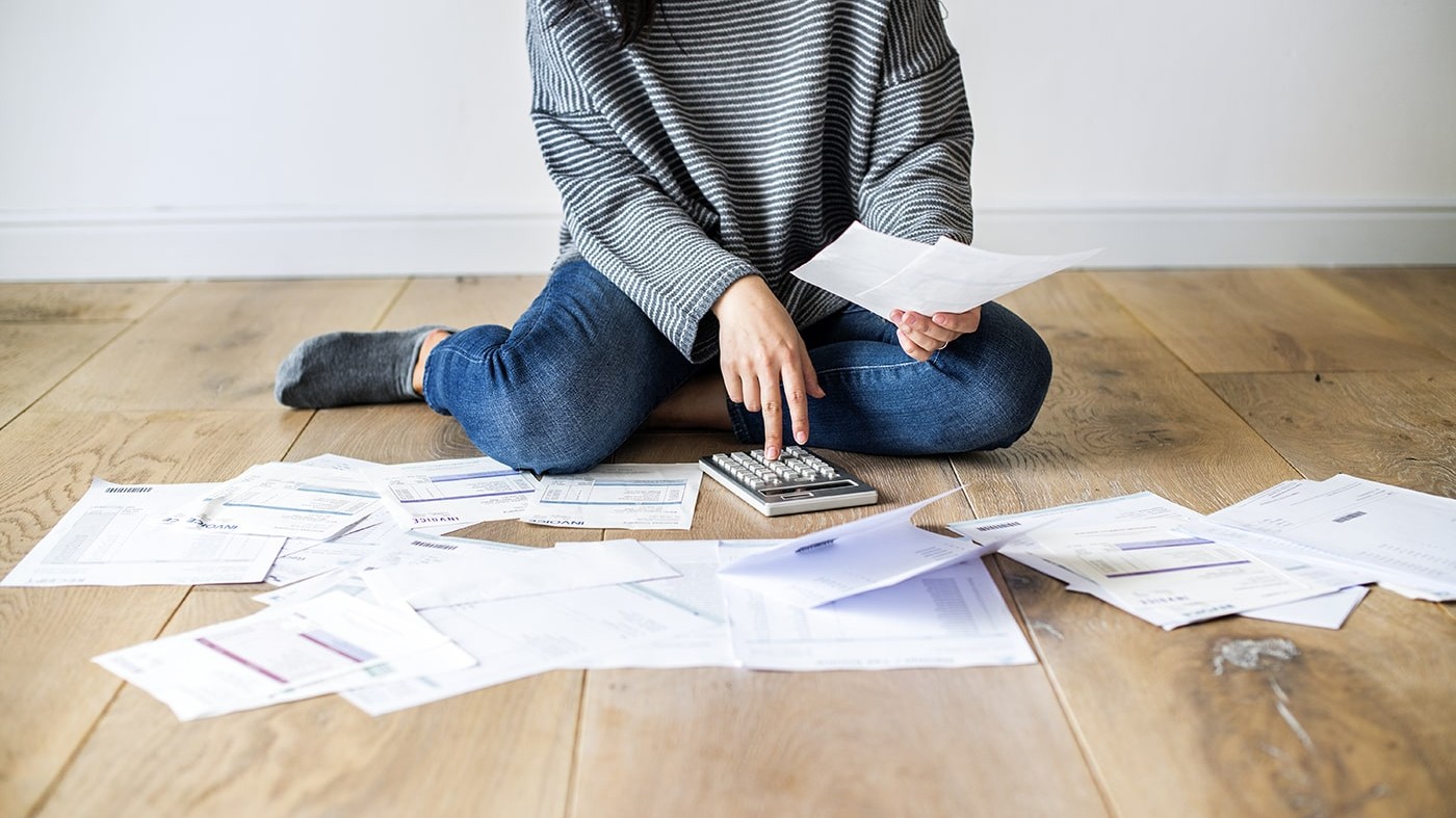 Woman reviewing various overhead expenses